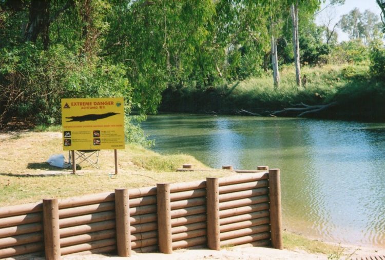 Crocodile warning sign, East Alligator River, Kakadu NP, Northern Territory